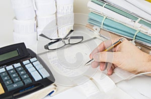 Bookkeeping files and tools with eyeglasses. Audit concept photo