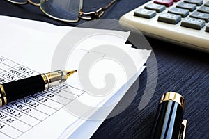 Bookkeeping. Financial report with figures and calculator on a desk. photo