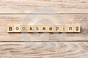 Bookkeeping word written on wood block. bookkeeping text on table, concept