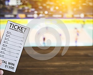 Bookmaker ticket on the background of a TV on which show volleyball, sports betting, volleyball