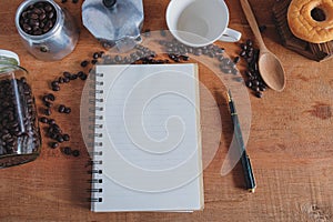 Booknote and pen on tabe with fresh coffee