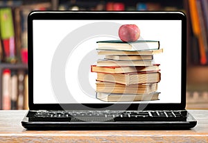 Books and apple on laptop screen