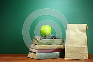 Books, Apple and Lunch on Teacher Desk