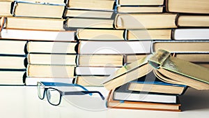 Books background, open book and glasses on white wooden table in office business background for education learning concept