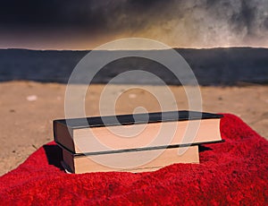 Books on beach with coming storm