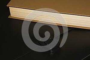 Books and a black folder on the table