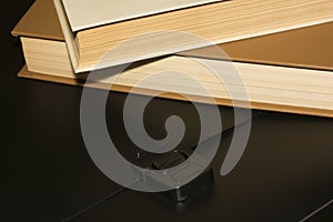 Books and a black folder on the table