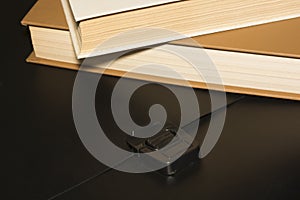 Books and a black folder on the table