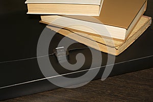 Books and a black folder on the table