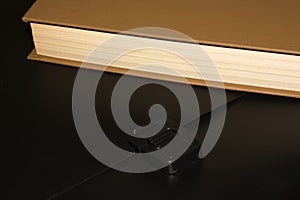 Books and a black folder on the table