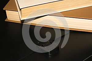 Books and a black folder on the table