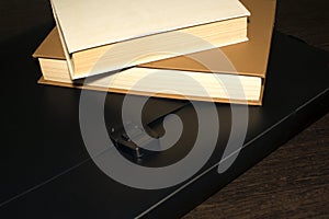 Books and a black folder on the table