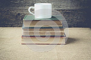 Books with coffe cup on retro background with Instagram Style F