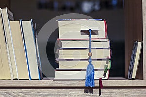 Books with colorful bookmarks on the wooden shelf.