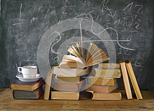 Books, cup of coffee, blackboard, diagram