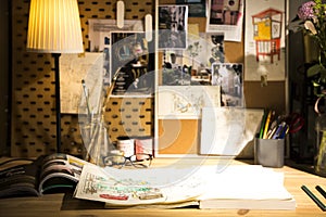 Books and drafts on wooden table under lamp light photo