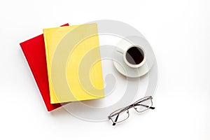 Books with empty cover near glasses, coffee on white desk background top view