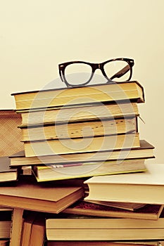 Books and eyeglasses in an old suitcase, with a retro effect photo