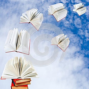 Books fly out of pile of books