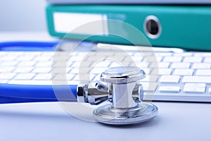 Books folder file, stethoscope and laptop, keyboard isolated on white background.