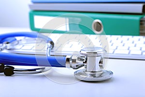 Books folder file, stethoscope and laptop, keyboard isolated on white background.