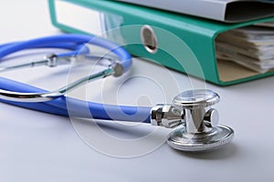 Books folder file, stethoscope, red heart and RX prescription isolated on white background.