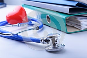 Books folder file, stethoscope, red heart and RX prescription isolated on white background.