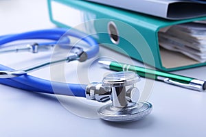 Books folder file, stethoscope, red heart and RX prescription isolated on white background.