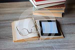 Books, Glasses, E-Reader and Bookshelf