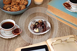 Books, Glasses, Tablet, Tea, Chocolate, Cookies and Candles