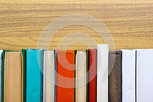 Books on grunge wooden table desk shelf in library. Back to school background with copy space for your ad text. Old