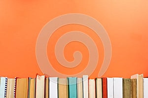 Books on grunge wooden table desk shelf in library. Back to school background with copy space for your ad text. Old