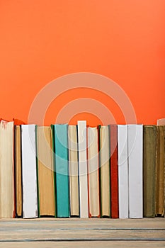 Books on grunge wooden table desk shelf in library. Back to school background with copy space for your ad text. Old