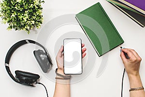 Books and headphones connected to them on a white background