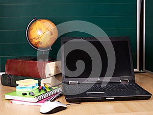 Books and laptop. School supplies.