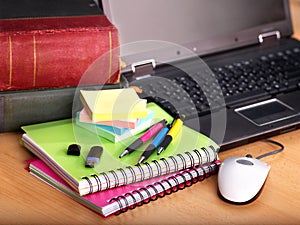 Books and laptop. School supplies.