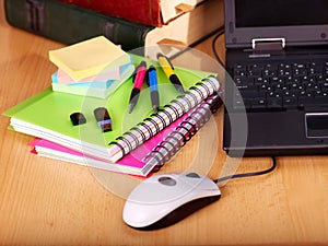 Books and laptop. School supplies.