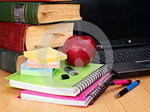 Books and laptop. School supplies.