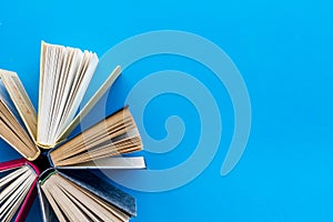 Books on library desk for reading and education on blue background top view mockup