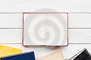 Books on library desk for reading and education on white wooden background top view mockup