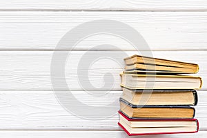 Books on library desk for reading and education on white wooden background top view mockup