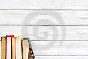 Books on library desk for reading and education on white wooden background top view mockup