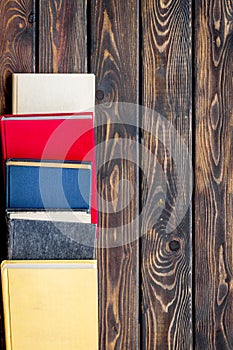 Books on library desk for reading and education on wooden background top view mockup