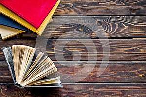 Books on library desk for reading and education on wooden background top view mockup