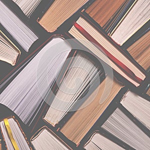 Books. Lots of colourful thick open books stand on a dark background