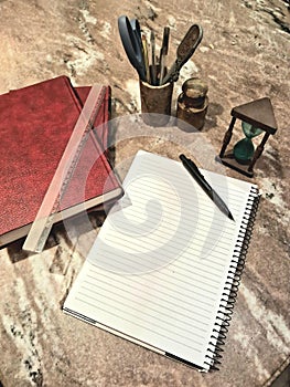 books and notebook on marble table