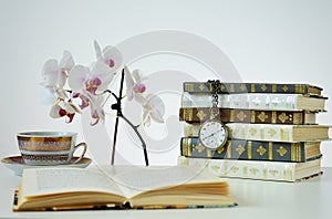 Books with old watch photo