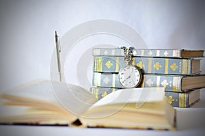 Books with old watch photo