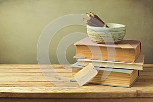 Books and pencils on wooden table in vintage style