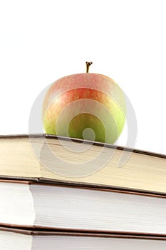 Books pyramid with apple on top